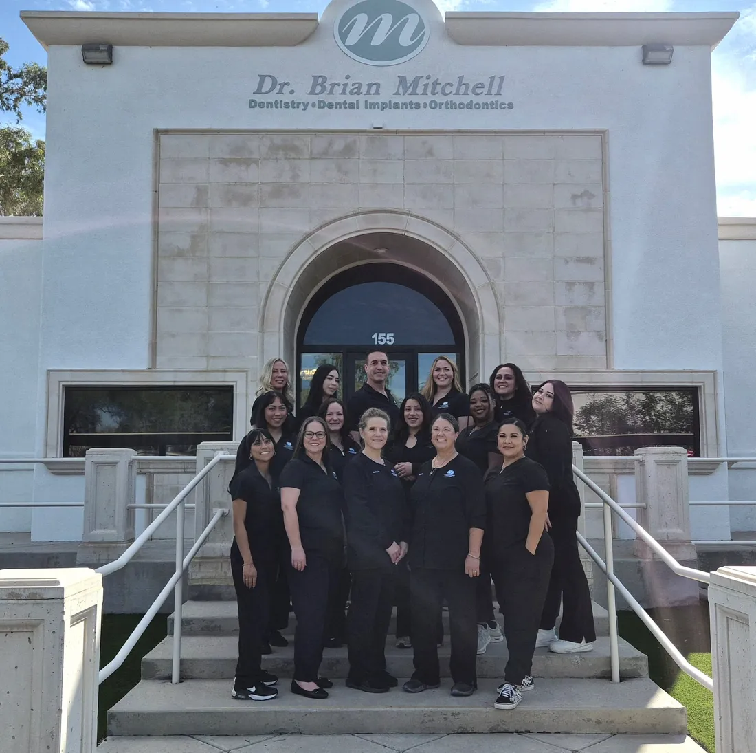 The Dr. Brian Mitchell & Associates team outside the practice at 6383 E. Grant Road